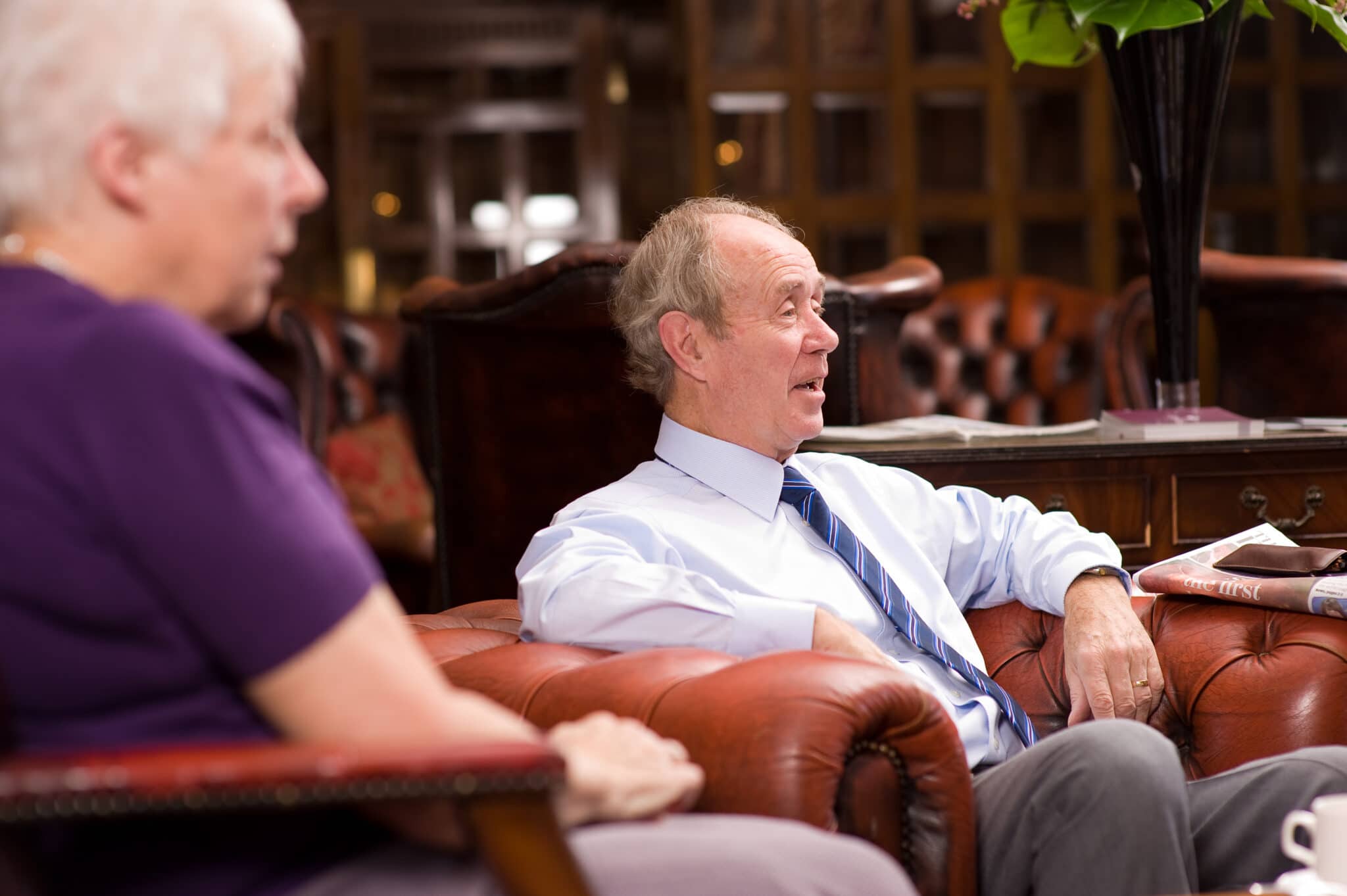 Happy older man lounging in an armchair