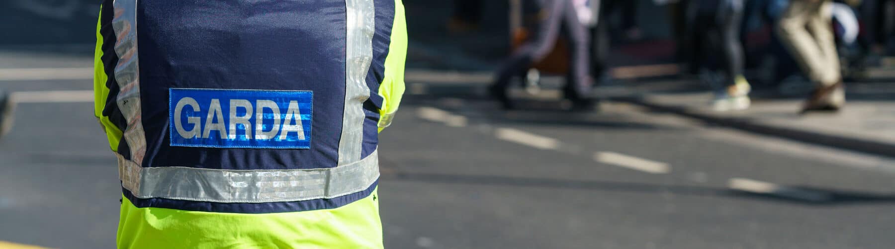 Garda standing on the street looking diligent