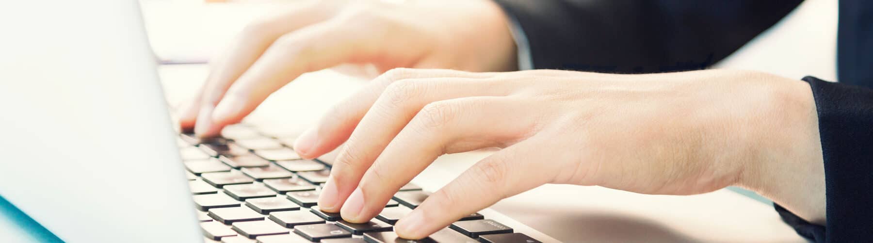 close up of person's hands checking their laptop